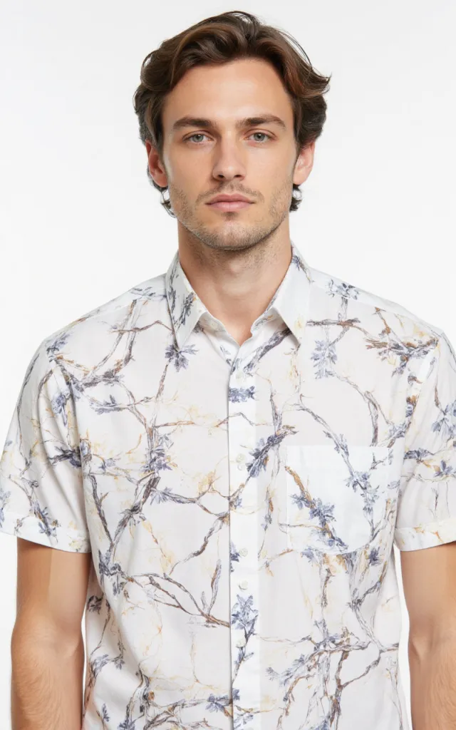 A French model wearing a Branch pattern   printed shirt, against a white background, in a front   facing bust portrait